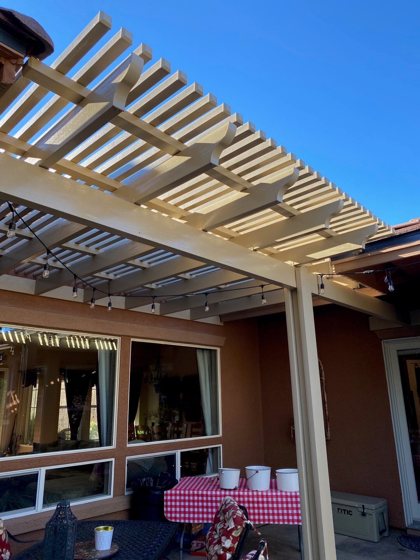 Aluminum lattice patio cover detail showing beams rafters and filtered shade